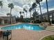 A community pool surrounded by palm trees and lounge chairs, creating a resort-like atmosphere at 75 N Valle Verde Dr # 625, Henderson, NV 89074