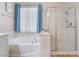Bright bathroom featuring a soaking tub under a window next to glass enclosed shower at 7559 Chambery Cove Ct, Las Vegas, NV 89123