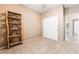 Empty spare bedroom featuring carpet, rustic shelving and sliding door closet at 7559 Chambery Cove Ct, Las Vegas, NV 89123