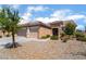 Charming single-story home with a three-car garage and well-maintained desert landscaping in front yard at 7559 Chambery Cove Ct, Las Vegas, NV 89123
