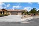 Inviting one-story home with three car garage, desert landscaping, and spacious driveway on a sunny day at 7559 Chambery Cove Ct, Las Vegas, NV 89123