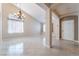 Spacious and open living room with tile flooring, high ceilings, neutral paint and natural light at 7559 Chambery Cove Ct, Las Vegas, NV 89123