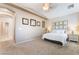 Neutral primary bedroom with carpet, ceiling fan and neutral paint, offers a calm respite at 7559 Chambery Cove Ct, Las Vegas, NV 89123
