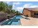 Sparkling backyard pool and spa with desert landscaping and privacy fence at 7559 Chambery Cove Ct, Las Vegas, NV 89123