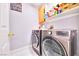 Spacious laundry room boasts stainless steel washer and dryer, plus plenty of room for storage above at 7909 Sierra Rim Dr, Las Vegas, NV 89131