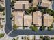 Aerial view of tan homes featuring tile roofs, manicured lawns, and neighborhood streets at 81 Alpine Bay Ave, Las Vegas, NV 89148
