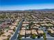 Residential neighborhood with similar homes boasting tan exteriors, tile roofs, and well-maintained yards at 81 Alpine Bay Ave, Las Vegas, NV 89148