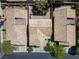 Overhead view of a tan home with a tile roof surrounded by similar residences and manicured landscaping at 81 Alpine Bay Ave, Las Vegas, NV 89148