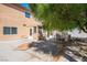 View of the back of the house and the backyard area with shade trees and patio at 81 Alpine Bay Ave, Las Vegas, NV 89148