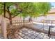 Backyard featuring a quaint patio area beneath a large shade tree at 81 Alpine Bay Ave, Las Vegas, NV 89148