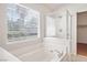 Bright bathroom with a soaking tub, glass-enclosed shower, and a large window at 81 Alpine Bay Ave, Las Vegas, NV 89148