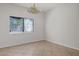 Neutral-toned bedroom with natural light, tile floors, and a chandelier at 81 Alpine Bay Ave, Las Vegas, NV 89148