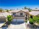 Inviting two-story home featuring a tile roof, manicured lawn, and a convenient two-car garage at 81 Alpine Bay Ave, Las Vegas, NV 89148