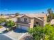 Inviting two-story home featuring a tile roof, manicured lawn, and a convenient two-car garage at 81 Alpine Bay Ave, Las Vegas, NV 89148