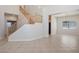 Open foyer area with staircase, neutral tile flooring, and a view into the adjacent living spaces at 81 Alpine Bay Ave, Las Vegas, NV 89148