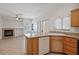 Open-concept kitchen with laminate countertops, a fireplace, and a kitchen island at 81 Alpine Bay Ave, Las Vegas, NV 89148