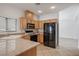 Well-lit kitchen featuring wooden cabinets, laminate countertops, and a black refrigerator at 81 Alpine Bay Ave, Las Vegas, NV 89148