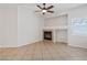 Inviting living room with a cozy fireplace, neutral paint, and tile flooring at 81 Alpine Bay Ave, Las Vegas, NV 89148
