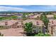 An aerial view of a well-maintained community with terracotta roofs, lush trees, and manicured green spaces at 8408 White Eagle Ave # 101, Las Vegas, NV 89145