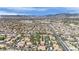An aerial view shows a well-planned residential community featuring terracotta roofs, lush trees, with mountain views at 8408 White Eagle Ave # 101, Las Vegas, NV 89145
