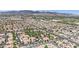 A serene aerial shot shows a dense residential community with terracotta roofs against a mountain backdrop at 8408 White Eagle Ave # 101, Las Vegas, NV 89145