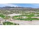 Expansive aerial view of lush golf course community with scenic mountain backdrop under clear blue sky at 8408 White Eagle Ave # 101, Las Vegas, NV 89145