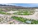 A tranquil view showing a neighborhood bordered by a golf course, tennis courts, and desert landscape with distant mountains at 8408 White Eagle Ave # 101, Las Vegas, NV 89145
