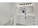 Bright bathroom featuring a modern vanity with black hardware, a toilet, and neutral tile flooring at 8408 White Eagle Ave # 101, Las Vegas, NV 89145