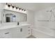 Modern bathroom with a sleek vanity, elegant mirror, and a soaking tub at 8408 White Eagle Ave # 101, Las Vegas, NV 89145