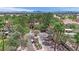 Gated entrance to a neighborhood featuring lush landscaping, mature trees, and well-maintained greenery all around at 8408 White Eagle Ave # 101, Las Vegas, NV 89145