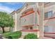 Exterior view of residential building with desert-style architecture, balcony and mature landscaping at 8408 White Eagle Ave # 101, Las Vegas, NV 89145