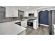 Modern kitchen features white cabinets, stainless steel appliances, and a stylish backsplash at 8408 White Eagle Ave # 101, Las Vegas, NV 89145