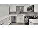 Modern kitchen with white cabinetry, quartz countertops, and stainless steel appliances at 8408 White Eagle Ave # 101, Las Vegas, NV 89145