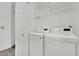 Laundry room featuring a full size washer and dryer, a door, and wire shelving at 8408 White Eagle Ave # 101, Las Vegas, NV 89145