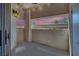 Outdoor patio with a view of the sunset, string lights, and privacy walls at 8408 White Eagle Ave # 101, Las Vegas, NV 89145