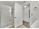 Bright bathroom featuring a walk-in shower, neutral tile flooring, and an open view of the single sink vanity at 8408 White Eagle Ave # 101, Las Vegas, NV 89145