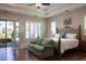 Primary bedroom featuring wood floors, French doors, plantation shutters and an iron bedframe at 8620 W La Madre Way, Las Vegas, NV 89149