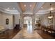 Open-concept living space with coffered ceilings, stone archway, tile floors and backyard access at 8620 W La Madre Way, Las Vegas, NV 89149