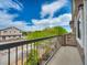 A bright balcony view showcasing nearby buildings and verdant, lush trees and blue sky at 8728 Tom Noon Ave # 103, Las Vegas, NV 89178