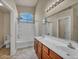 Bright bathroom with double vanity, tub-shower combo, and large mirror reflecting the space at 8728 Tom Noon Ave # 103, Las Vegas, NV 89178
