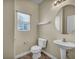 Cozy half-bathroom featuring a pedestal sink and window with blinds for natural light at 8728 Tom Noon Ave # 103, Las Vegas, NV 89178