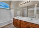 Bright bathroom featuring a dual sink vanity and a shower-tub combination at 8728 Tom Noon Ave # 103, Las Vegas, NV 89178