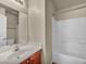 Bathroom with a vanity, sink, and a bathtub with white tile surround at 8728 Tom Noon Ave # 103, Las Vegas, NV 89178