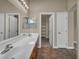 Bathroom featuring a double sink vanity, large mirror, and a view into a walk-in closet at 8728 Tom Noon Ave # 103, Las Vegas, NV 89178