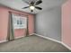 Neutral bedroom with plush carpeting, ceiling fan, and large window at 8728 Tom Noon Ave # 103, Las Vegas, NV 89178