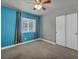 Bright bedroom features a ceiling fan, neutral carpet, and natural light at 8728 Tom Noon Ave # 103, Las Vegas, NV 89178