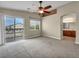 Carpeted bedroom with balcony access and an open doorway leading to an en suite bathroom at 8728 Tom Noon Ave # 103, Las Vegas, NV 89178