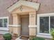 Inviting home entrance with a covered porch, complemented by manicured bushes and bright windows at 8728 Tom Noon Ave # 103, Las Vegas, NV 89178