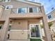Exterior view of a home with a balcony, covered patio, and neutral stucco at 8728 Tom Noon Ave # 103, Las Vegas, NV 89178