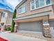 Two-story exterior with a gray garage door at 8728 Tom Noon Ave # 103, Las Vegas, NV 89178